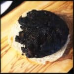 Cooked Bury Black Pudding on oven bottom muffin base