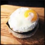 Cooked Bury Black Pudding and Fried Egg on oven bottom muffin base